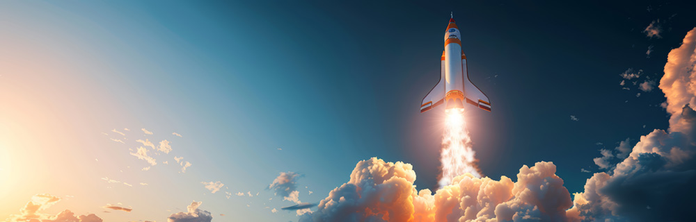 Rocket launching with fiery exhaust against blue sky